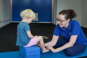 Paediatric physiotherapist assessing a toddler